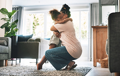 Buy stock photo Shot of a mother and child hugging at home
