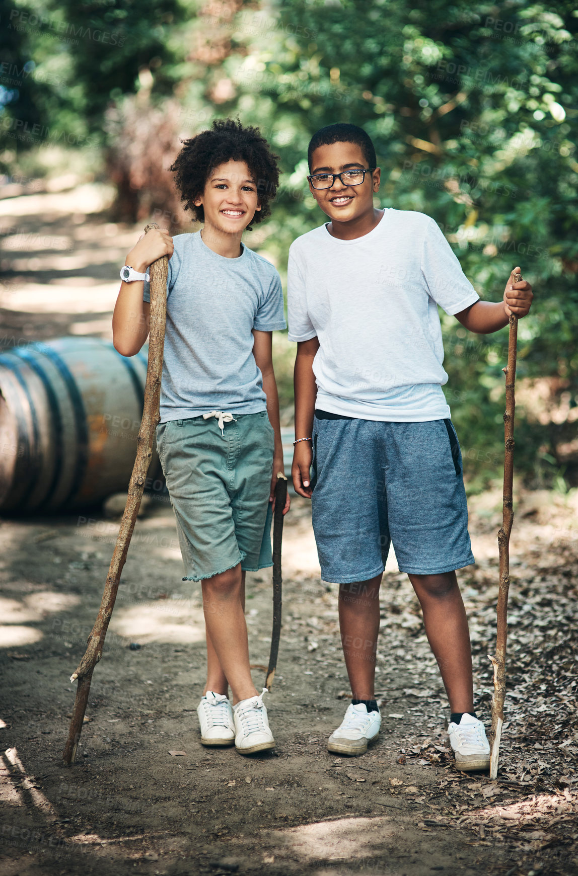 Buy stock photo Shot of two teenage boys exploring nature at summer camp