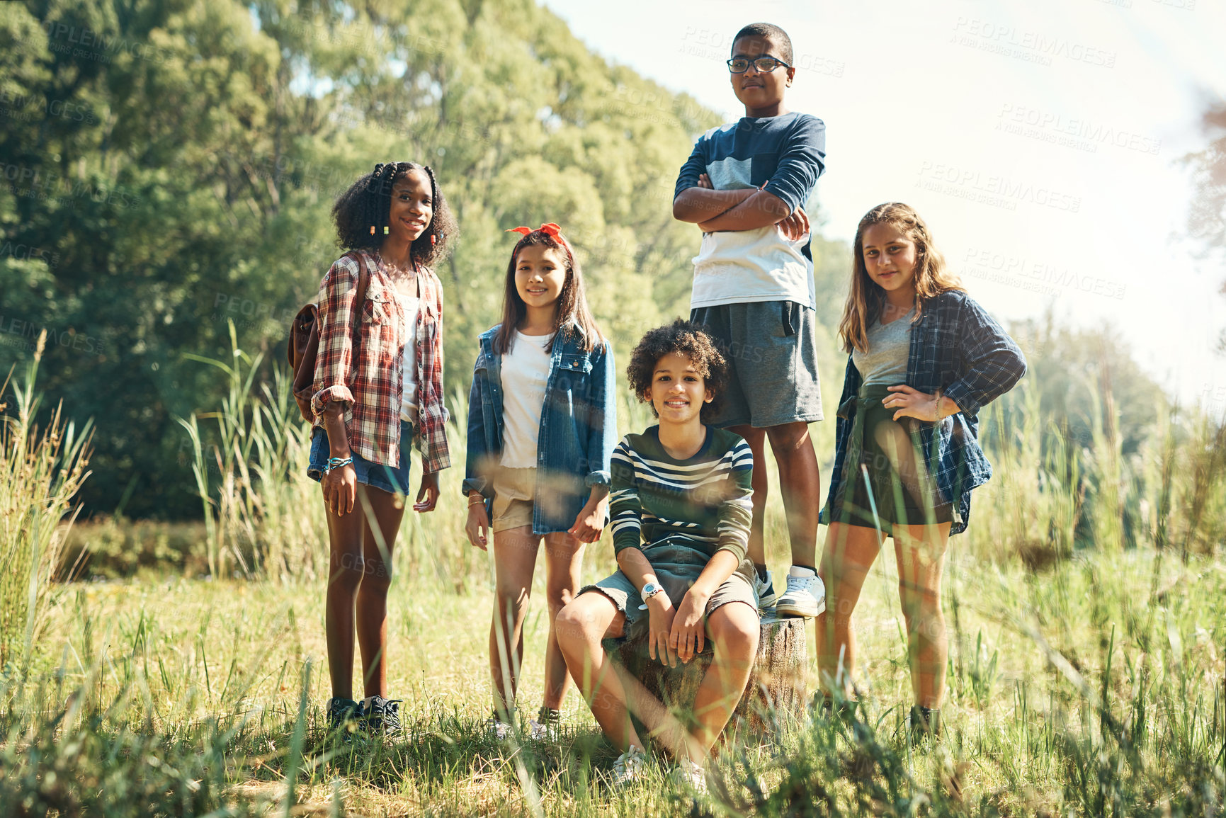 Buy stock photo Shot of a group of teenagers having fun in nature at summer camp