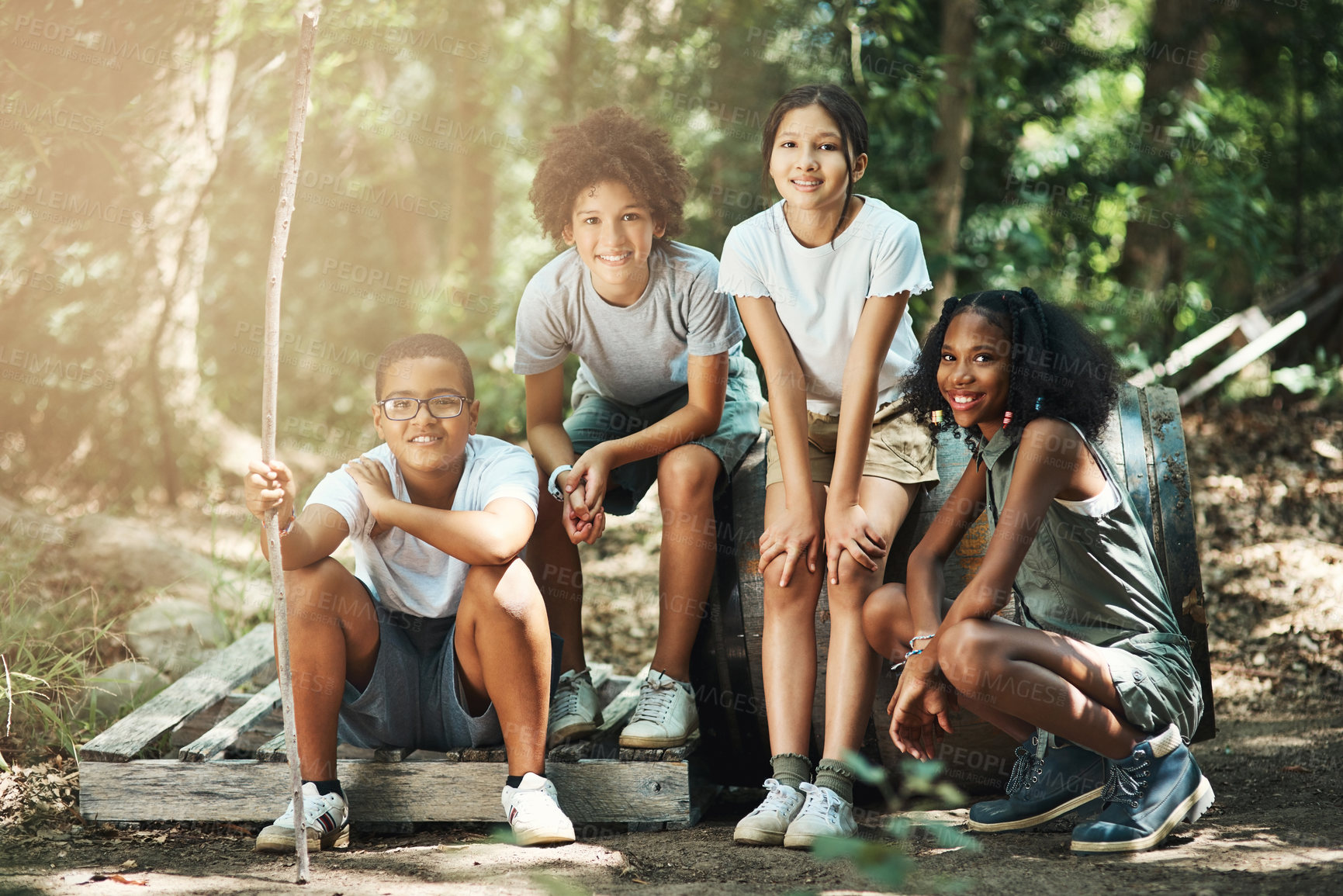 Buy stock photo Shot of a group of teenagers having fun in nature at summer camp