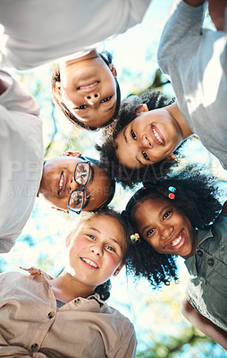 Buy stock photo Shot of a group of teenagers standing in a circle in nature at summer camp