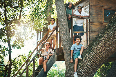 Buy stock photo Shot of a group of teenagers standing next to a treehouse at summer camp