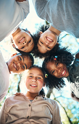 Buy stock photo Shot of a group of teenagers standing in a circle in nature at summer camp