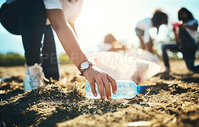 Buy stock photo Shot of an unrecognisable teenager picking up litter off a field at summer camp