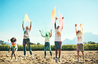 Buy stock photo Shot of a group of teenagers having fun with colourful powder at summer camp