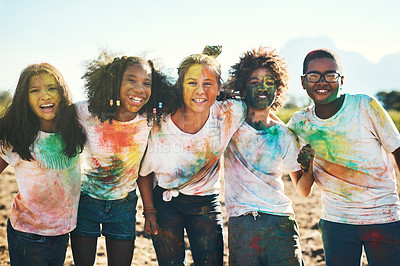 Buy stock photo Shot of a group of teenagers having fun with colourful powder at summer camp