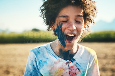 Buy stock photo Shot of a teenage boy having fun with colourful powder at summer camp