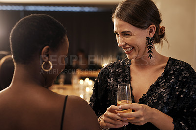 Buy stock photo Shot of an attractive young woman bonding with her friends during a New Year's dinner party