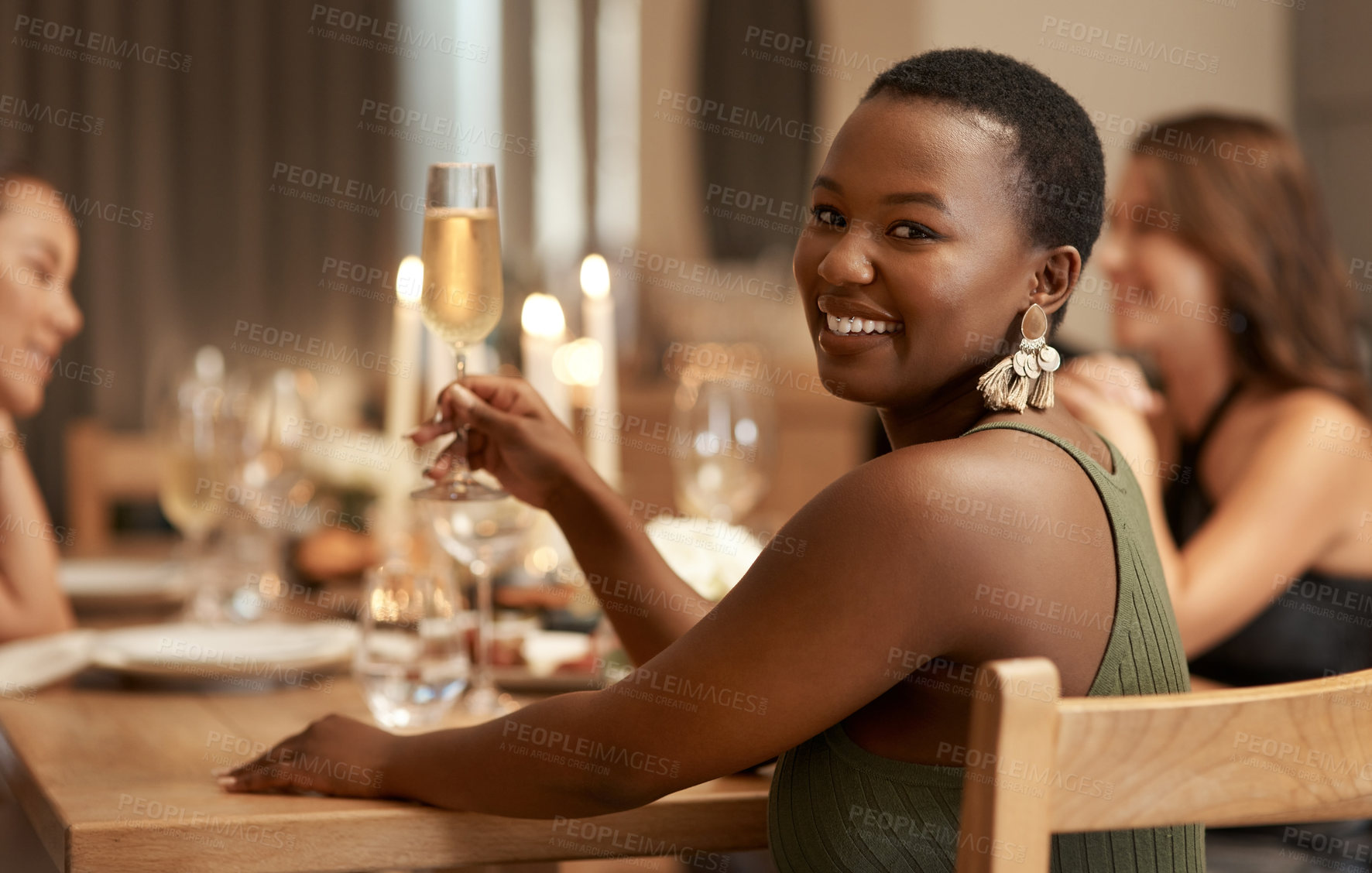 Buy stock photo Friends, champagne and portrait girl at dinner celebration party to celebrate happy new year in house dining room. Candle, home fine dining and black woman at social holiday event with alcohol drinks