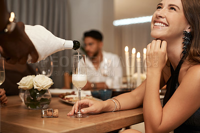 Buy stock photo Party, pouring champagne and woman at a dinner event with friends to celebrate New Years eve. Friendship, serving sparkling wine or alcohol at a fine dining gathering while celebrating 