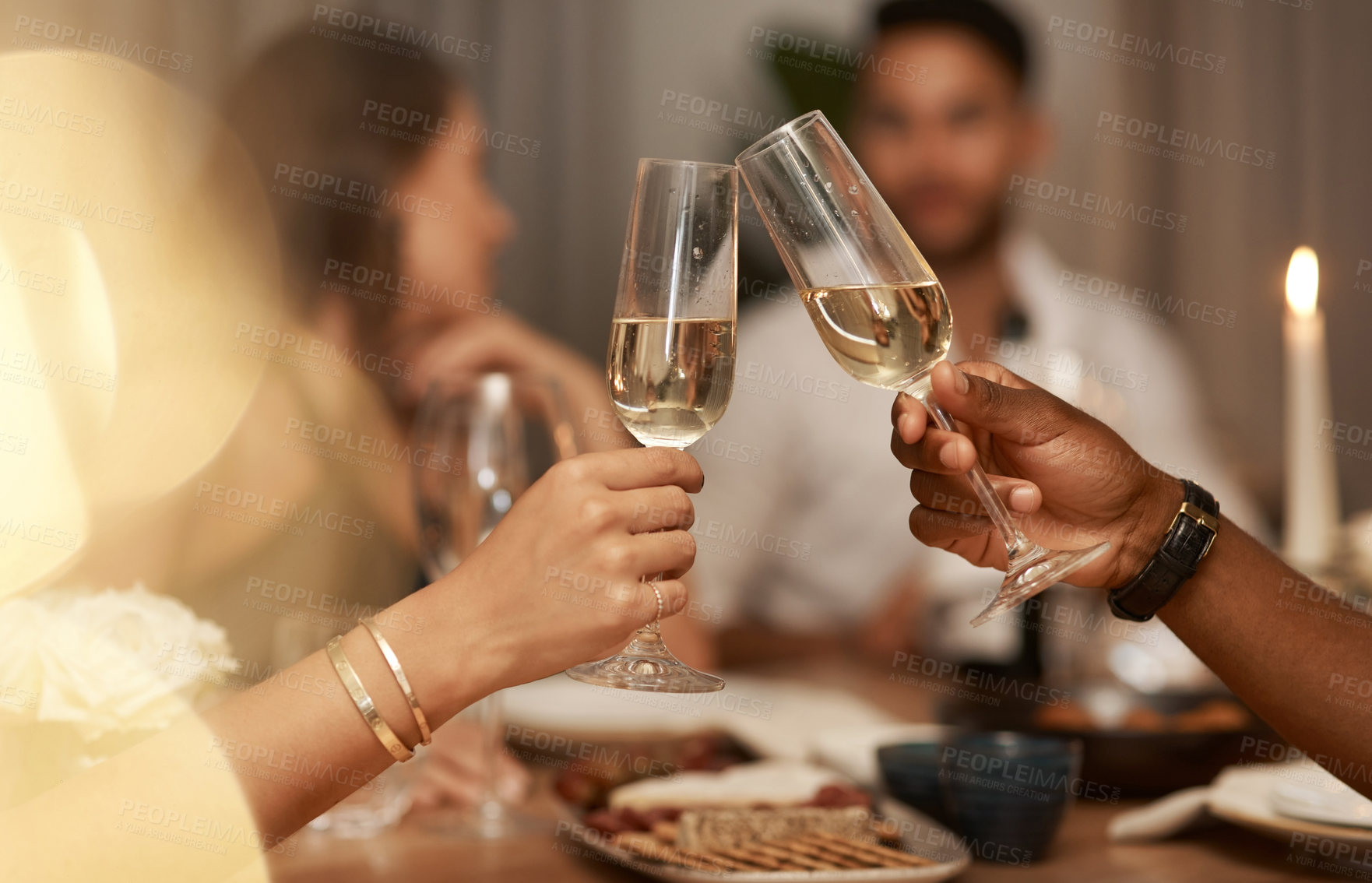 Buy stock photo Closeup, champagne and glasses for celebration, party or friends enjoy New Years dinner or drinks together. Hands, toast and alcohol for drinking, event and food for social gathering, cheers or relax