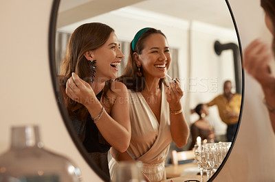 Buy stock photo Woman, friends and smile for mirror, makeup or cosmetics together in the bathroom at event or dinner party. Happy women laughing and smiling applying cosmetic treatment for skincare in reflection