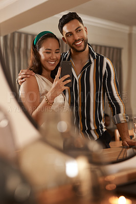 Buy stock photo Dinner party, celebration and couple with selfie on a phone in mirror enjoy holiday, festival and Christmas party. Social event, restaurant and young happy man and woman take picture with smartphone
