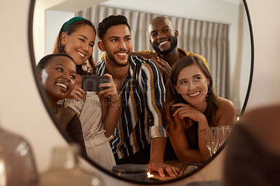 Buy stock photo Group of friends, phone and mirror selfie for party, celebration or New Years together. Young people reflection, diversity or smartphone to connect, smile or social gathering to enjoy dinner or relax