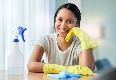 Buy stock photo Shot of a young woman wearing gloves at home