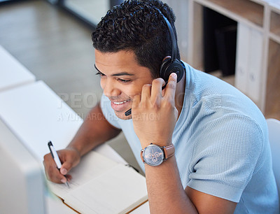 Buy stock photo Above shot of a young man working in a call center in an office