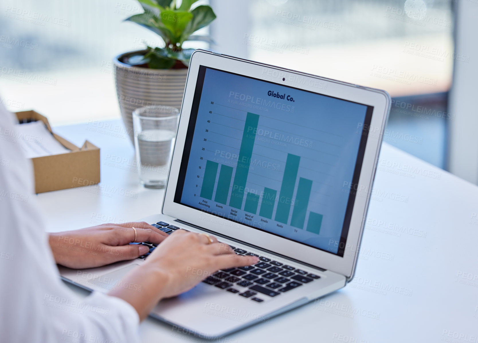 Buy stock photo Cropped shot of a businesswoman using a laptop in a modern office