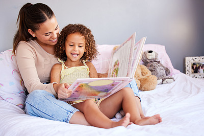 Buy stock photo Learning, book and mother with daughter in bedroom for storytelling, fantasy or creative. Education, study and love with woman reading to young girl in family home for fairytale, literature and relax