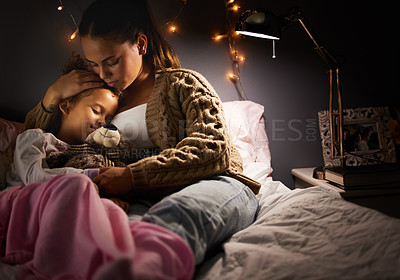 Buy stock photo Shot of a mother holding her daughter while she sleeps