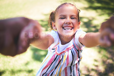 Buy stock photo Shot of a young girl being swung by her hands in the park