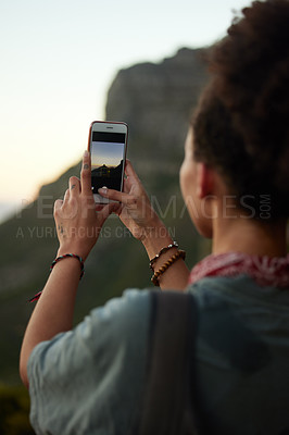 Buy stock photo Woman, phone and picture for social media, sunset and adventure in mountains for holiday. Influencer, mobile and travel on cliff for outdoor scenery, relax and female person in nature for vacation