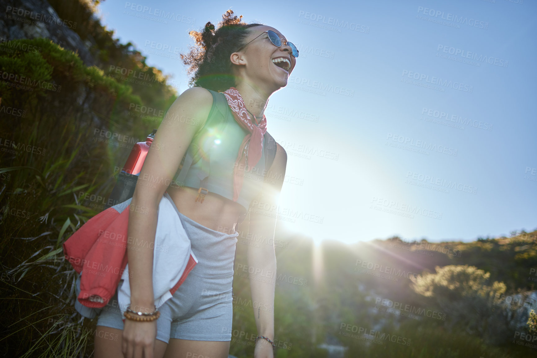 Buy stock photo Fitness, sport and woman hiking with smile in nature for wellness, exercise and walking adventure. Happy, female athlete and sunglasses for morning workout or training outdoors with lens flare