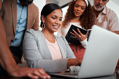 Buy stock photo Shot of a group of businesspeople gathered around their manager using a laptop
