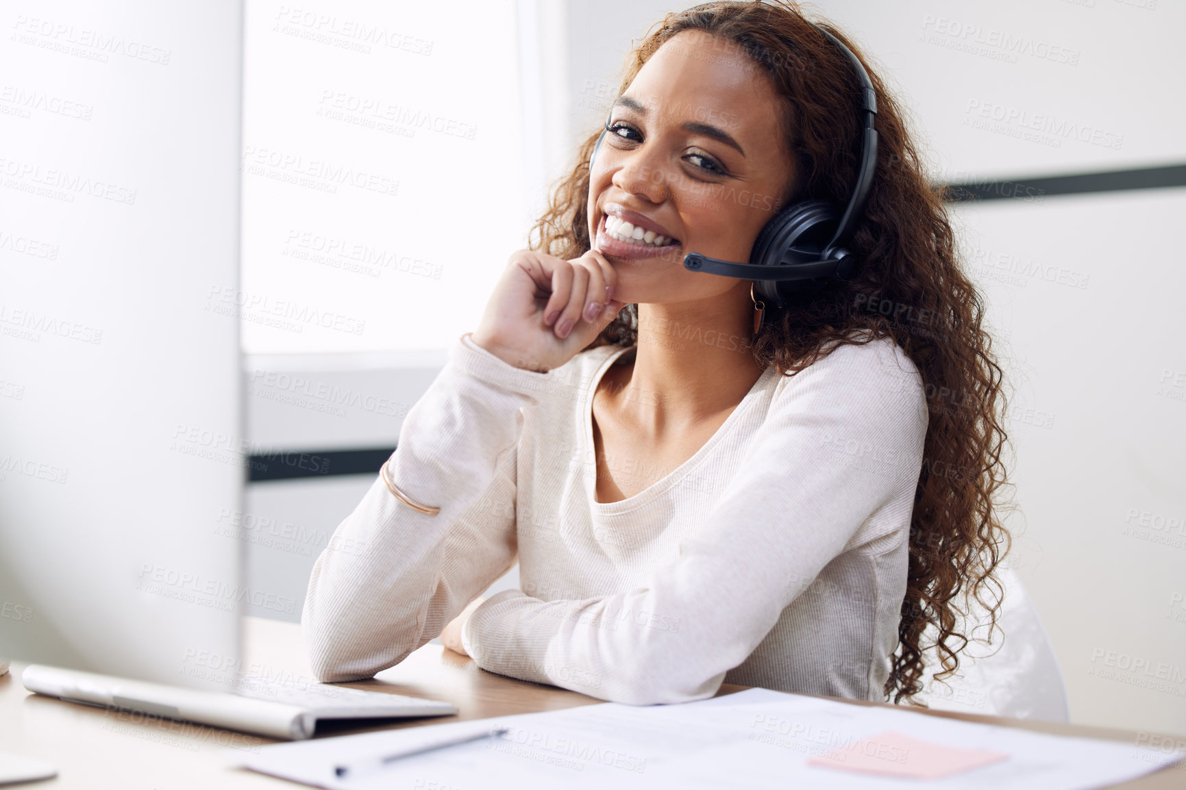 Buy stock photo Cropped portrait of an attractive young female call center agent working at her desk in the office