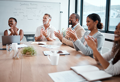Buy stock photo Shot of a group of businessmen and women applauding during a meeting