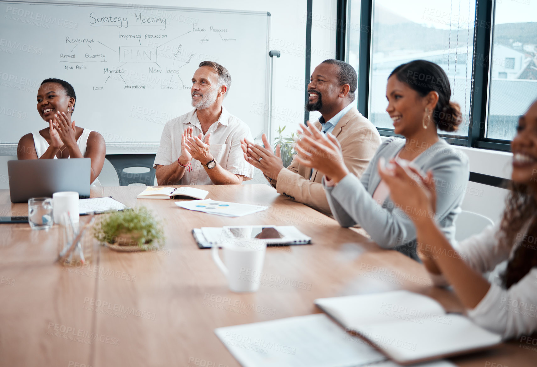 Buy stock photo Shot of a group of businessmen and women applauding during a meeting