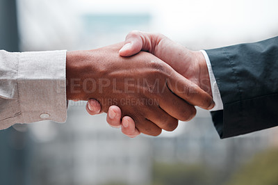 Buy stock photo Cropped shot of two unrecognizable businessmen shaking hands while standing in their office