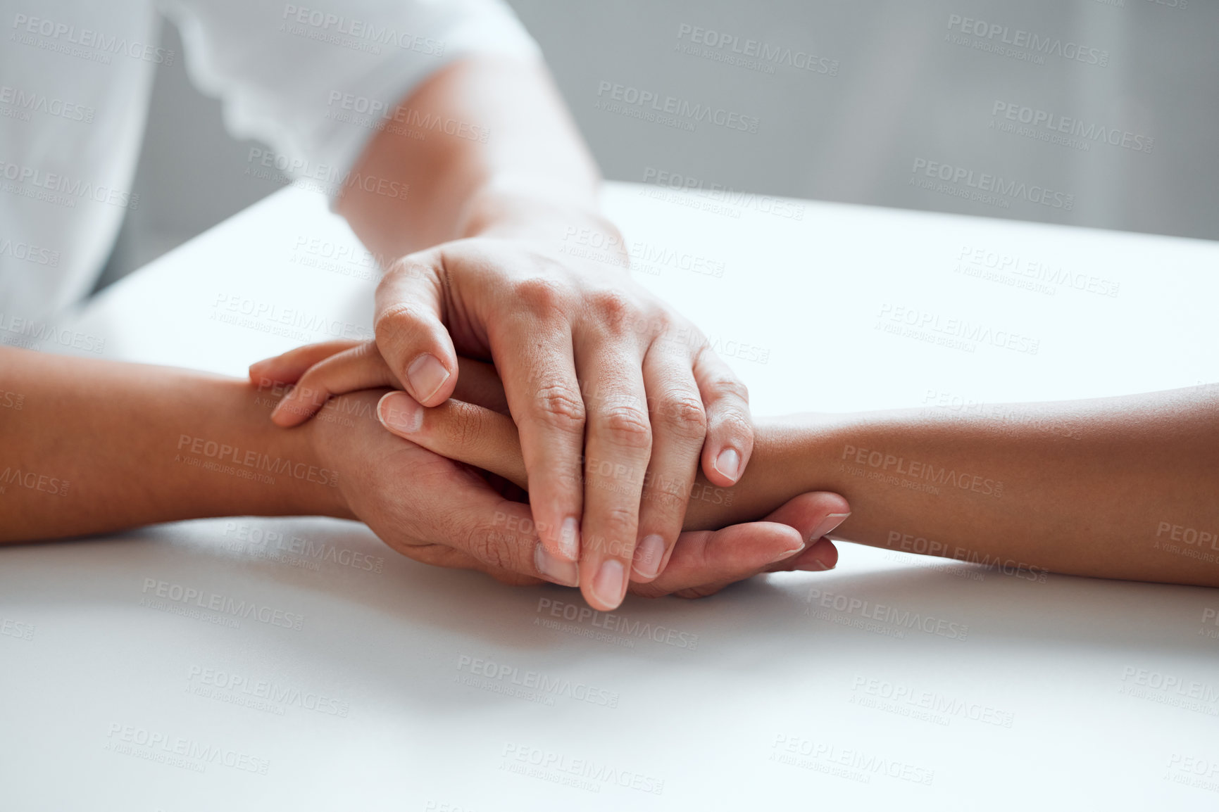 Buy stock photo Hands, support and hope for console or care on table, comfort empathy for bad news or illness. Closeup, people and unity in crisis by prayer, trust or bond for person suffering with diagnosis