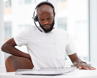 Buy stock photo Black man, call centre and headset with back pain, office and customer support at desk. Hurt, inflammation and muscle strain on spine with ache, telemarketing agent or medical problem for male person