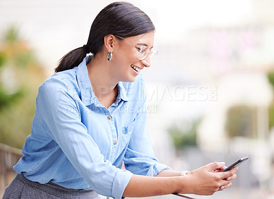 Buy stock photo Shot of a young businesswoman using her smartphone to send text messages