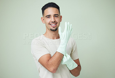 Buy stock photo Man, cleaner and portrait with gloves in studio for housework, spring cleaning and housekeeping. Person, face and happy with protection for dirt, dust or safety for domestic chores on lime background