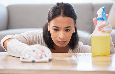 Buy stock photo Shot of a young woman cleaning a surface at home
