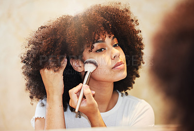 Buy stock photo Shot of a beautiful young woman using a makeup brush on her face