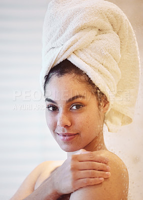 Buy stock photo Shot of a young woman wearing a towel around her head while in the shower
