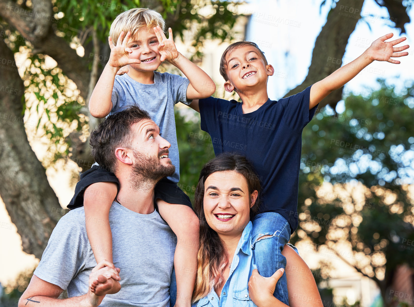 Buy stock photo Portrait, park and parents with children on shoulder for fun outdoor bonding, vacation adventure and smile. Mother, father and excited kids in garden for happy family on holiday together in summer.