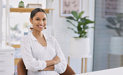 Buy stock photo Portrait of a young businesswoman sitting at a desk in a modern office
