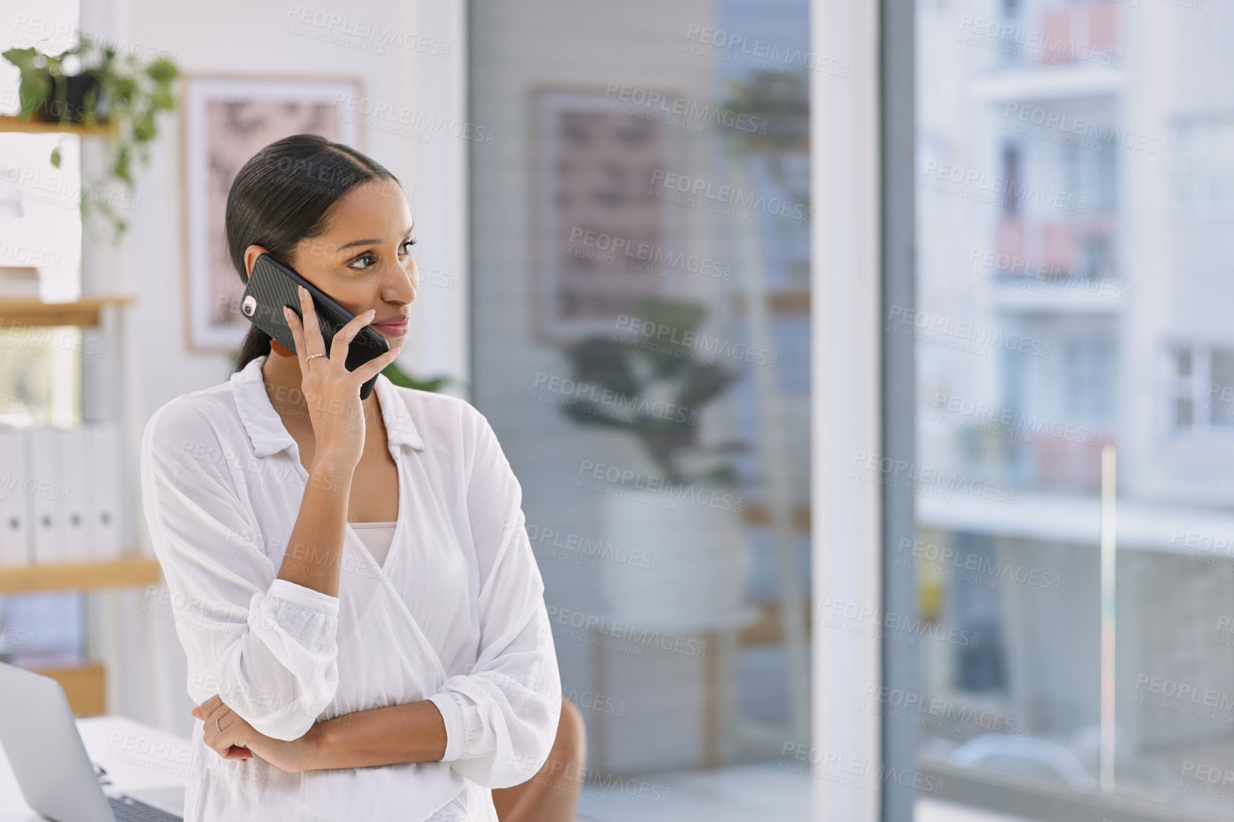 Buy stock photo Shot of a businesswoman on a phone call in a modern office