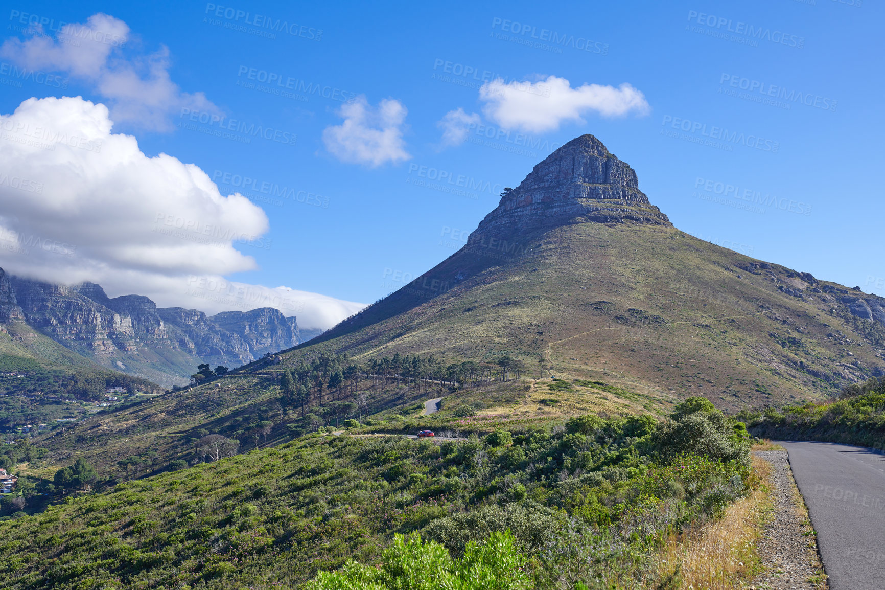 Buy stock photo Lion's Head mountain and green, natural landscape in Cape Town, South Africa. Outdoor hiking spot with blue sky backdrop and plants by a road. Beautiful view of nature while traveling.