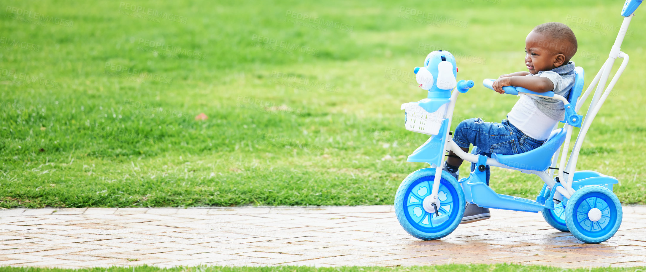 Buy stock photo African boy, bike and park for learning, childhood and nature with tears and crying. Child, grass and scared for push bicycle ride, sad toddler and grumpy emotional distress in garden or lawn