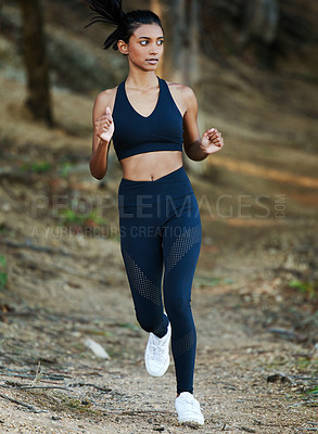 Buy stock photo Woman is running in forest, fitness and cardio in nature with exercise and healthy, active lifestyle. Female runner outdoor, training for marathon with speed, energy and workout for health and sport