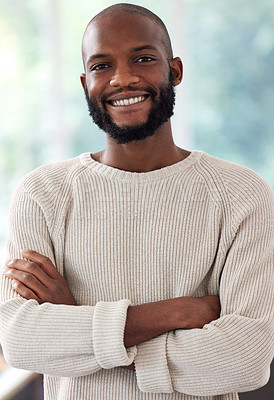 Buy stock photo African man, portrait and happy with arms crossed in home for relax, confidence or pride for weekend off. Black person, face and smile with casual fashion, cozy or comfortable in living room of house