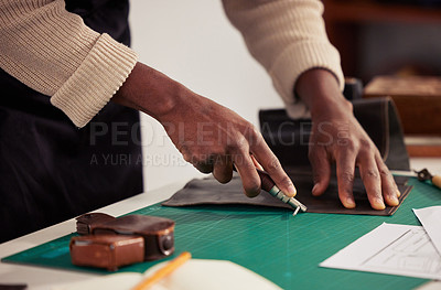 Buy stock photo Cropped shot of an unrecognizable male designer working with leather in his design studio