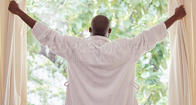 Buy stock photo Shot of a young man opening curtains at home
