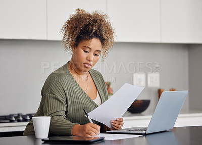 Buy stock photo Shot of a woman filling in some paperwork at home