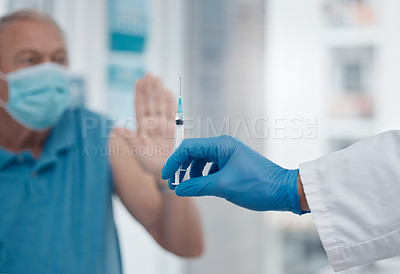 Buy stock photo Cropped shot of a senior man gesturing to stop an unrecognizable doctor from injecting him with the covid 19 vaccine