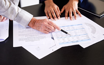Buy stock photo High angle shot of an unrecognizable female broker and her male client going over some paperwork in his home